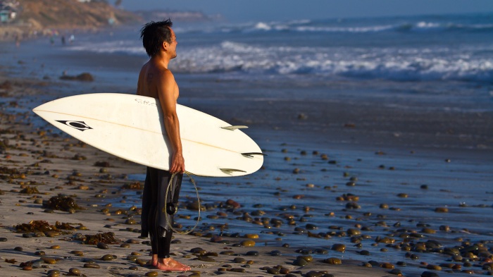 A surfer looks in Carlsbad, CA